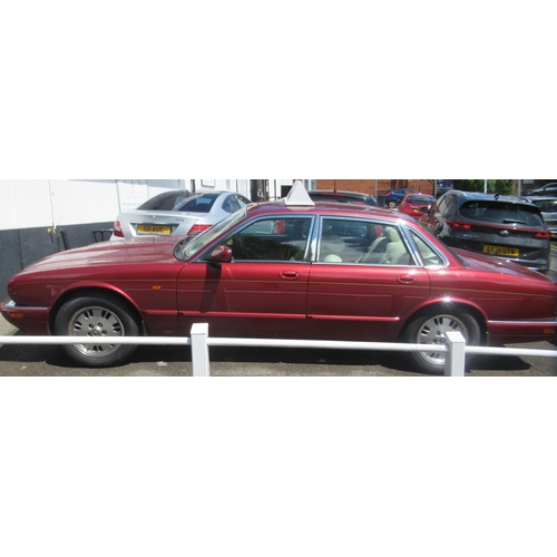 150 - A 1995 Jaguar Sovereign automatic 3.2ltr petrol, five door saloon in red livery with cream coloured ... 