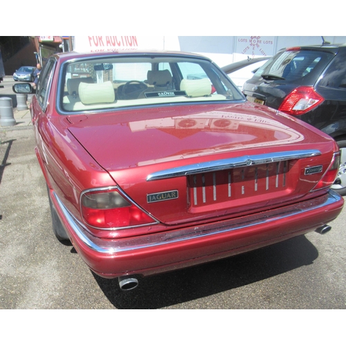 150 - A 1995 Jaguar Sovereign automatic 3.2ltr petrol, five door saloon in red livery with cream coloured ... 