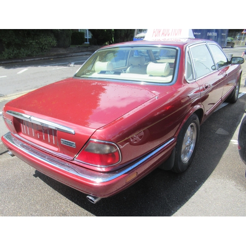 150 - A 1995 Jaguar Sovereign automatic 3.2ltr petrol, five door saloon in red livery with cream coloured ... 