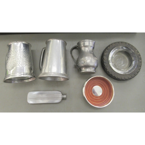 155 - Decorative and functional 20thC metalware: to include pewter tankards 