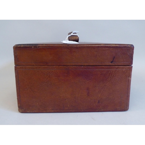 17 - A late Victorian/Edwardian tooled mid brown hide covered jewellery box, the hinged lid secured by a ... 