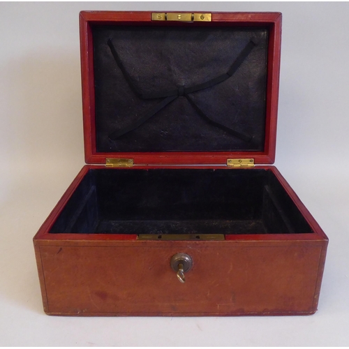 17 - A late Victorian/Edwardian tooled mid brown hide covered jewellery box, the hinged lid secured by a ... 