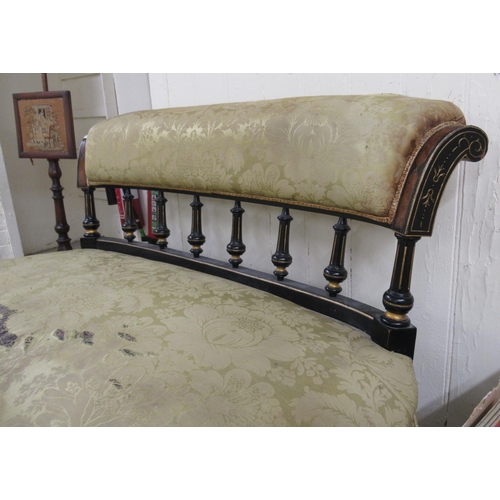 185 - A late Victorian ebonised and gilded showwood framed salon settee with a level, scrolled back on tur... 