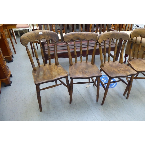 198 - A set of four early 20thC beech and elm framed Windsor kitchen chairs, the solid seats raised on tur... 