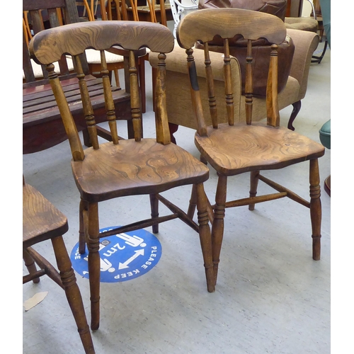 198 - A set of four early 20thC beech and elm framed Windsor kitchen chairs, the solid seats raised on tur... 