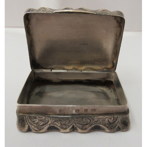 213 - A late Victorian silver snuff box of serpentine outline with a hinged lid  Birmingham 1897