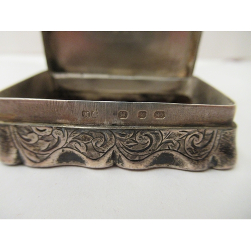 213 - A late Victorian silver snuff box of serpentine outline with a hinged lid  Birmingham 1897