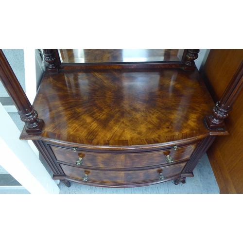 243 - A modern Brights of Nettlebed Victorian style mahogany finished bow front stand with a galleried top... 