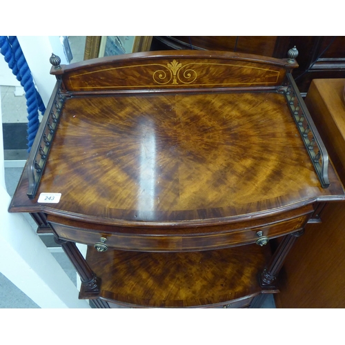 243 - A modern Brights of Nettlebed Victorian style mahogany finished bow front stand with a galleried top... 