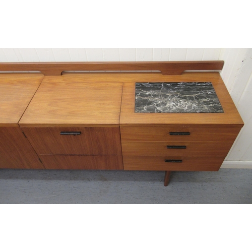 245 - A modern Uniflex Gunther Hoffstead  teak sideboard with a low railed back, the top incorporating an ... 