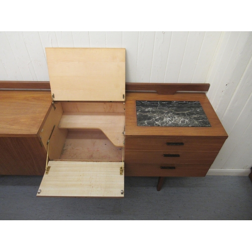 245 - A modern Uniflex Gunther Hoffstead  teak sideboard with a low railed back, the top incorporating an ... 