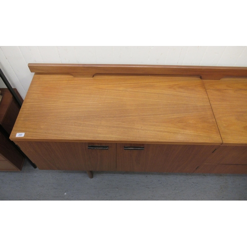 245 - A modern Uniflex Gunther Hoffstead  teak sideboard with a low railed back, the top incorporating an ... 