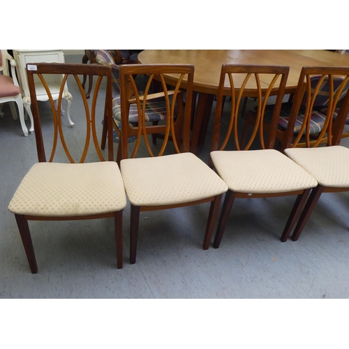 261 - A set of six G-Plan teak framed dining chairs with square, crinoline lath backs and upholstered seat... 