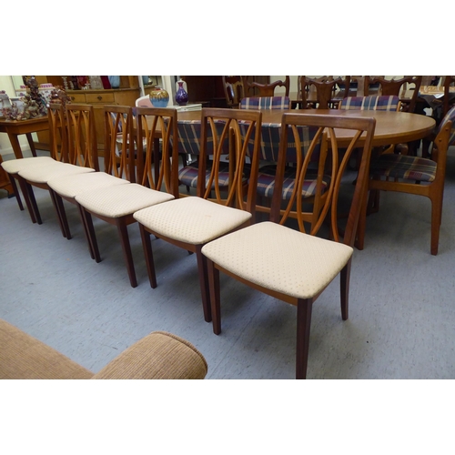 261 - A set of six G-Plan teak framed dining chairs with square, crinoline lath backs and upholstered seat... 