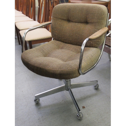 272 - A vintage desk chair, the fabric covered back and seat on a steel frame, rotating base and casters