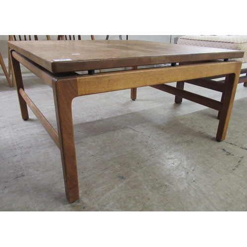 273 - A 1970s teak coffee table, raised on square legs  16