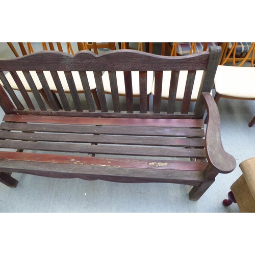 275 - A modern teak framed garden seat of slatted construction with level arms  60