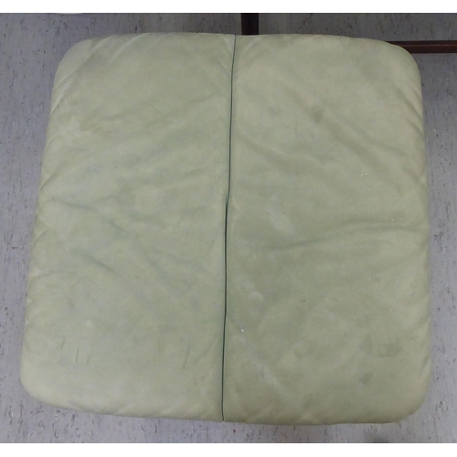 277 - A modern cushioned pale green soft hide upholstered, adjustable lounge chair with enclosed arms, rot... 