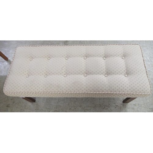 283 - A modern cushioned fabric upholstered window seat, raised on teak square legs