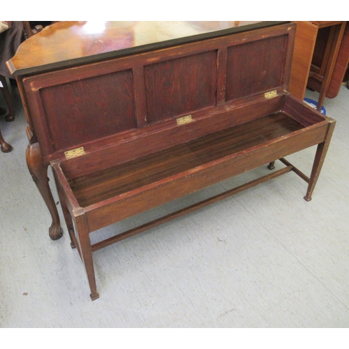 295 - An early 20thC mahogany framed window seat, raised on square, tapered legs