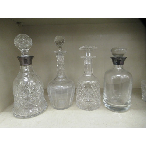 301 - Eight glass decanters with stoppers, two incorporating modern silver collars