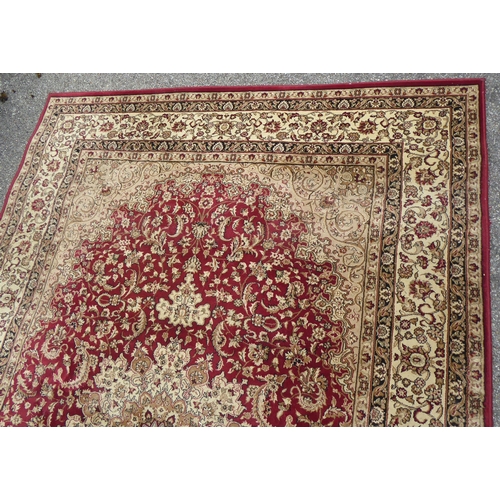 308 - A Tiara rug with floral motifs on a red ground  78