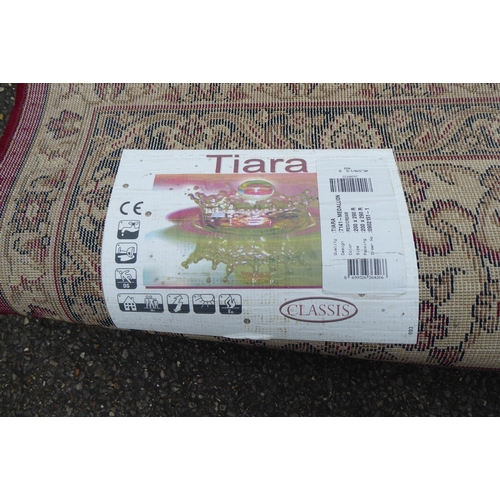 308 - A Tiara rug with floral motifs on a red ground  78