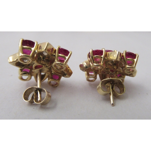 312 - A pair of 18ct gold claw set earrings, set with rubies and diamonds 