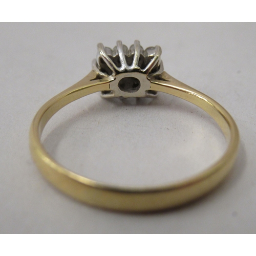 324 - A yellow metal ring, set with small diamonds