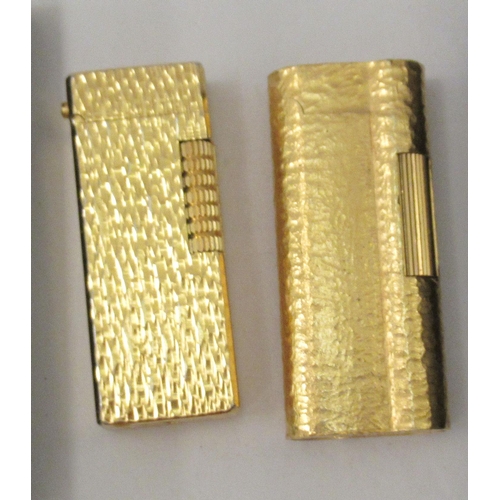 341 - A gold plated Dunhill lighter, model no.C62814; and another gold plated example