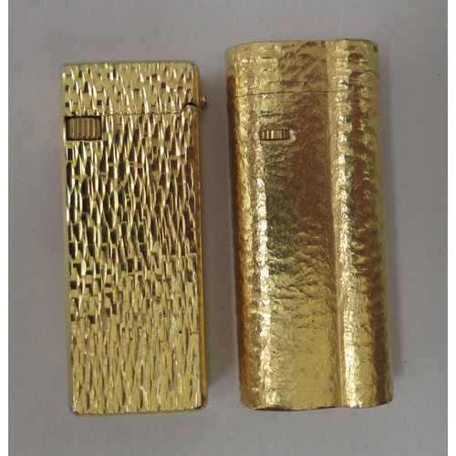 341 - A gold plated Dunhill lighter, model no.C62814; and another gold plated example