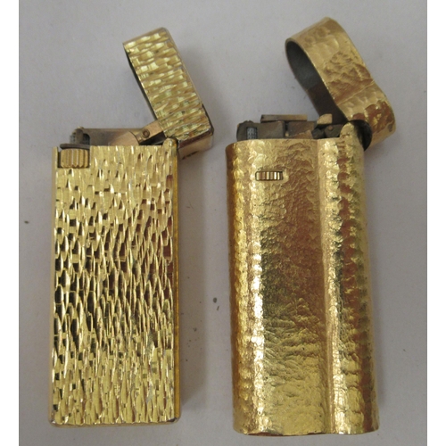 341 - A gold plated Dunhill lighter, model no.C62814; and another gold plated example