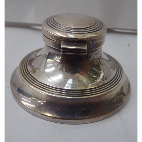 343 - A silver Capstan design inkwell  Birmingham 1925; and a Sterling silver cased pen  cased