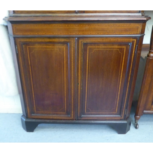 72 - A late 19thC/early 20thC satinwood inlaid and crossbanded mahogany standing corner cupboard with a s... 