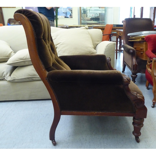 73 - A late Victorian carved mahogany showwood framed library chair with a high scrolled back and level e... 