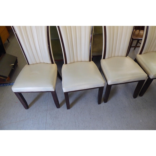 9 - A set of four modern dining chairs, having cream coloured, stitched hide fan design backs raised on ... 