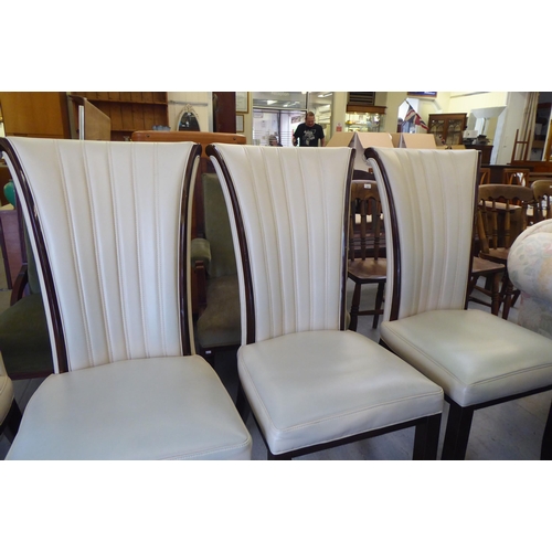 9 - A set of four modern dining chairs, having cream coloured, stitched hide fan design backs raised on ... 