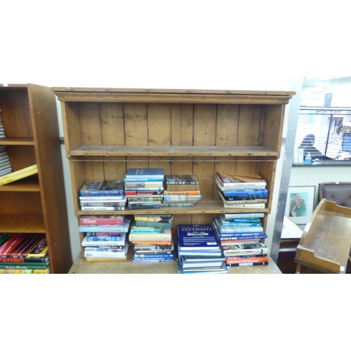 97 - An early 20thC pine dresser with a three tier plate rack, over two drawers and two panelled doors, o... 