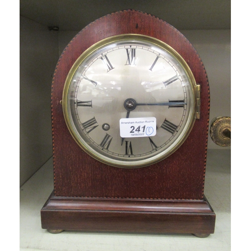 99 - An early 20thC mahogany cased mantel clock; the movement faced by a Roman dial  10