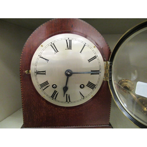 99 - An early 20thC mahogany cased mantel clock; the movement faced by a Roman dial  10