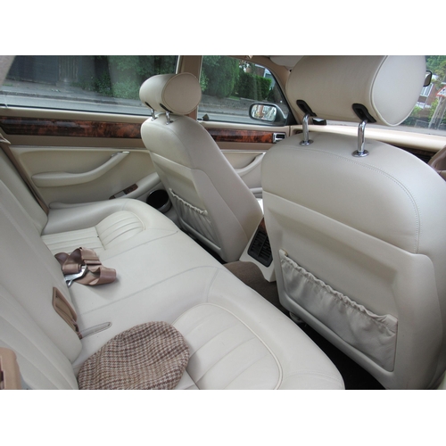 150 - A 1995 Jaguar Sovereign automatic 3.2ltr petrol, five door saloon in red livery with cream coloured ... 