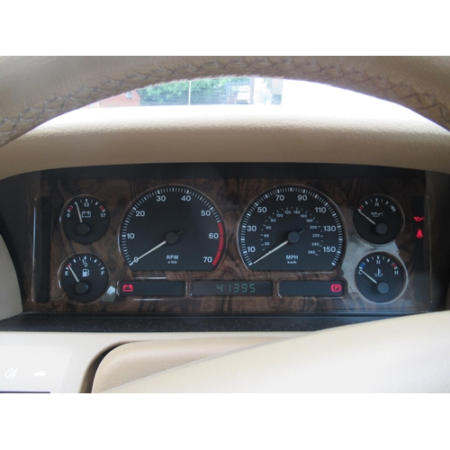 150 - A 1995 Jaguar Sovereign automatic 3.2ltr petrol, five door saloon in red livery with cream coloured ... 