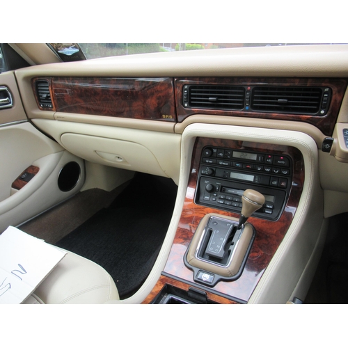 150 - A 1995 Jaguar Sovereign automatic 3.2ltr petrol, five door saloon in red livery with cream coloured ... 