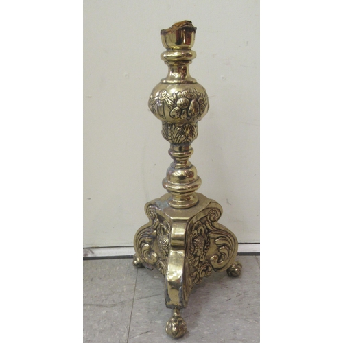 65 - An early 20thC cast brass jardinière with opposing mask ring handles, on a floral decorated c... 