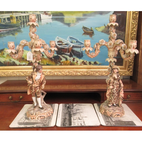 100 - A pair of post 1950s European (possibly Austrian) porcelain triple branch candelabra, decorated with... 