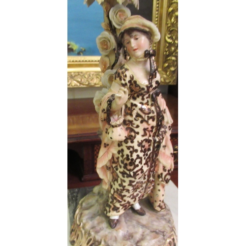 100 - A pair of post 1950s European (possibly Austrian) porcelain triple branch candelabra, decorated with... 