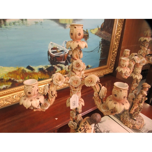 100 - A pair of post 1950s European (possibly Austrian) porcelain triple branch candelabra, decorated with... 