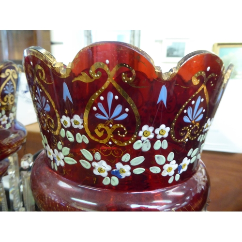 112 - A pair of late Victorian overpainted cranberry coloured glass lustre vases with clear crystal pendan... 
