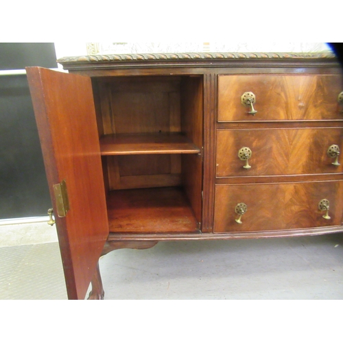 145 - A 1930s mahogany bow front sideboard with a central bank of three drawers, flanked by a pair of pane... 