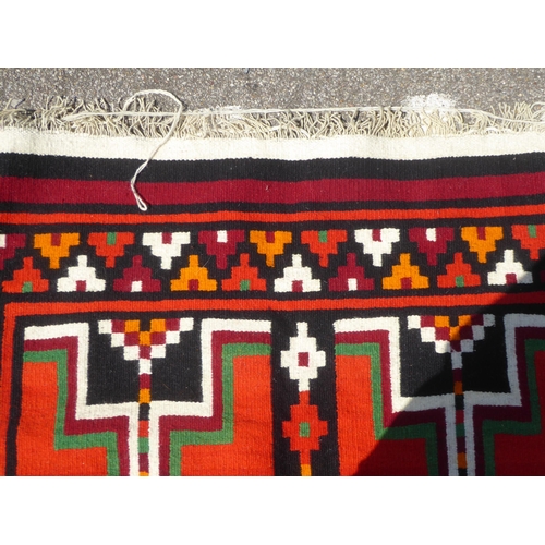 16 - A Kelim rug with geometric motifs, on a multi-coloured ground  52
